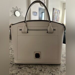 Cream Dooney and Bourke purse with white and navy blue striped interior